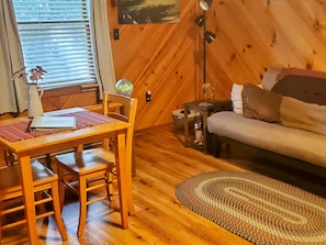 Relax in this inviting room with a dining table, sofa, and globe.
