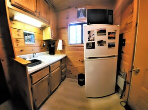 Enjoy cooking in this well-equipped kitchen with a sink, coffee maker, and refrigerator.