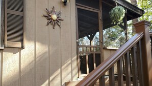 A wooden deck with a staircase leading to a covered porch. -  Convenient to downtown Asheville,  Biltmore Estate, and Blue Ridge Pky.   (Asheville)