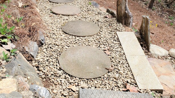 A stone pathway leading to a wooden cabin in a forested area. -  Convenient to downtown Asheville,  Biltmore Estate, and Blue Ridge Pky.   (Asheville)