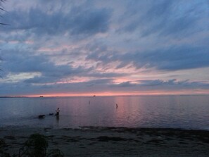 A calm body of water with a distant shoreline and a cloudy sky. - Romantic Escape; Open Gulf View; Your Own Private Dock!  Elevator to master. (Crystal Beach)
