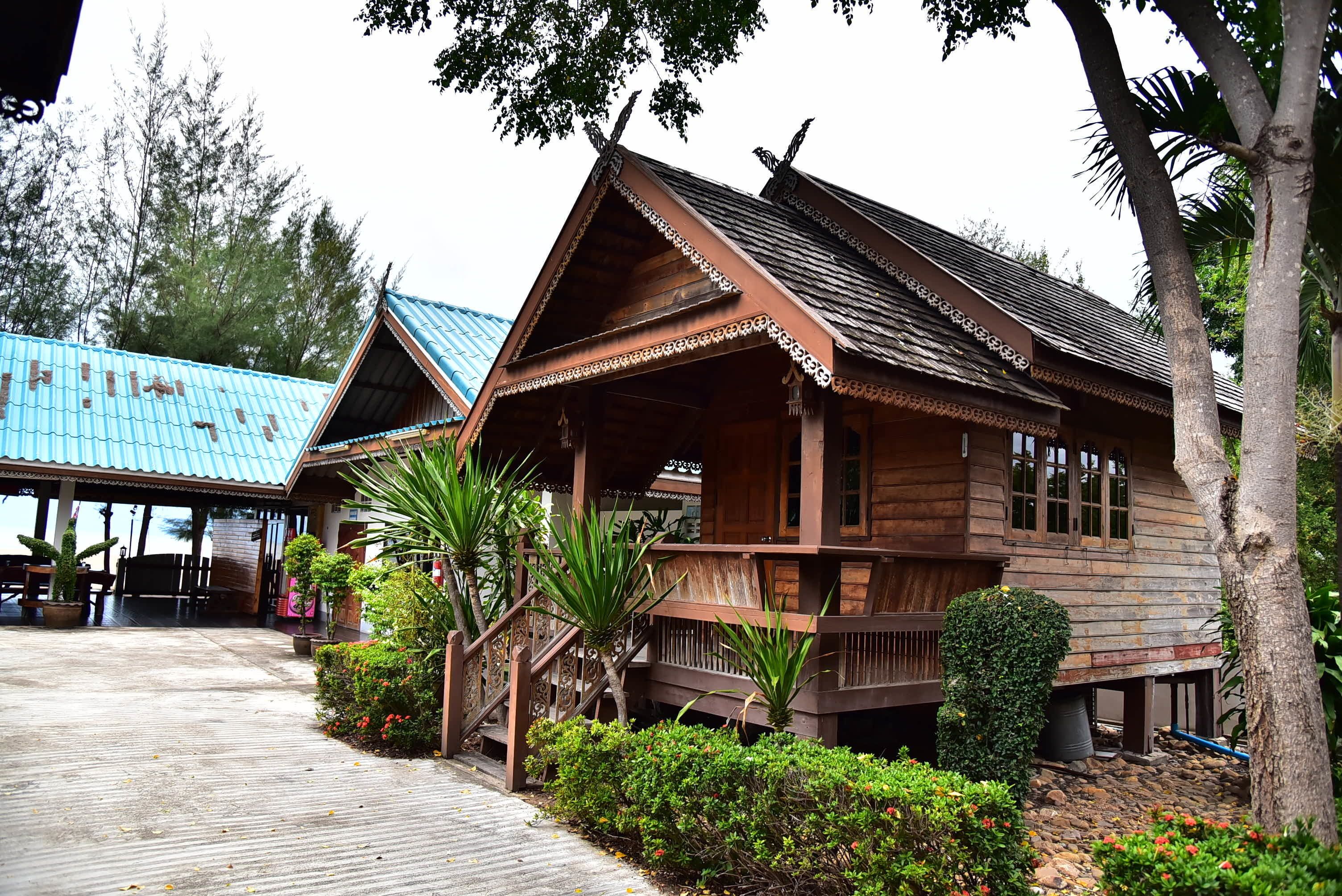 A traditional wooden building with a sloped roof and a porch.