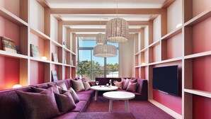 A modern living room with a sectional sofa, a flat-screen TV, and a dining table. - Hoshino Resorts RISONARE Yatsugatake (Hokuto)