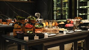 A buffet with various food stations including salads, fruits, and beverages. - Marriott Executive Apartments, Bangkok Townhall Sukhumvit (Bangkok)