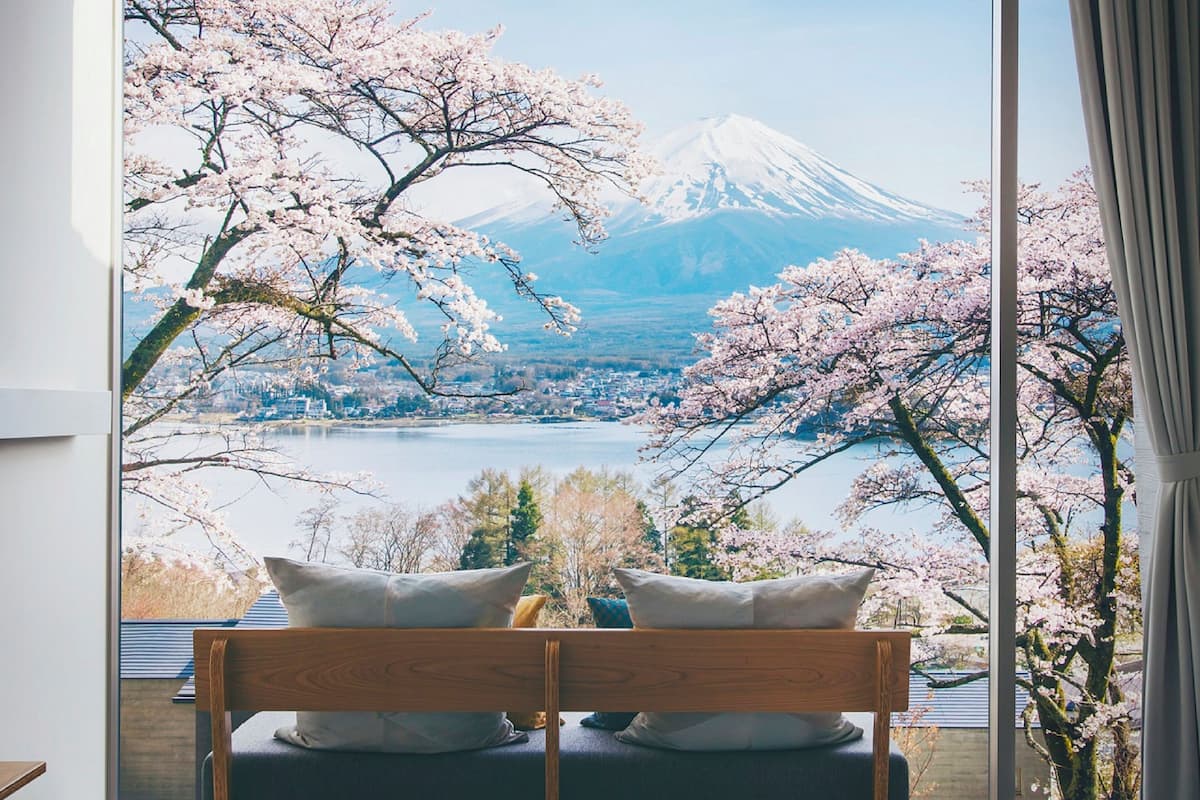 A bedroom with a view of Mount Fuji and cherry blossoms.