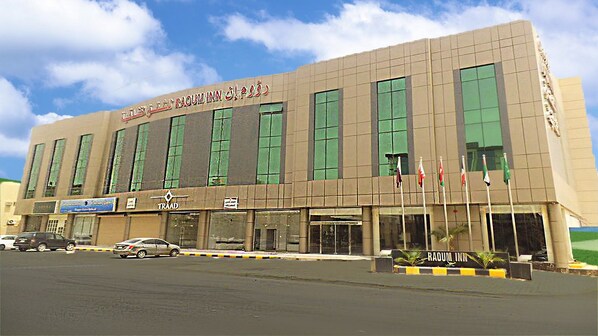 A building with a sign reading "RAQUIMANN HOTEL".