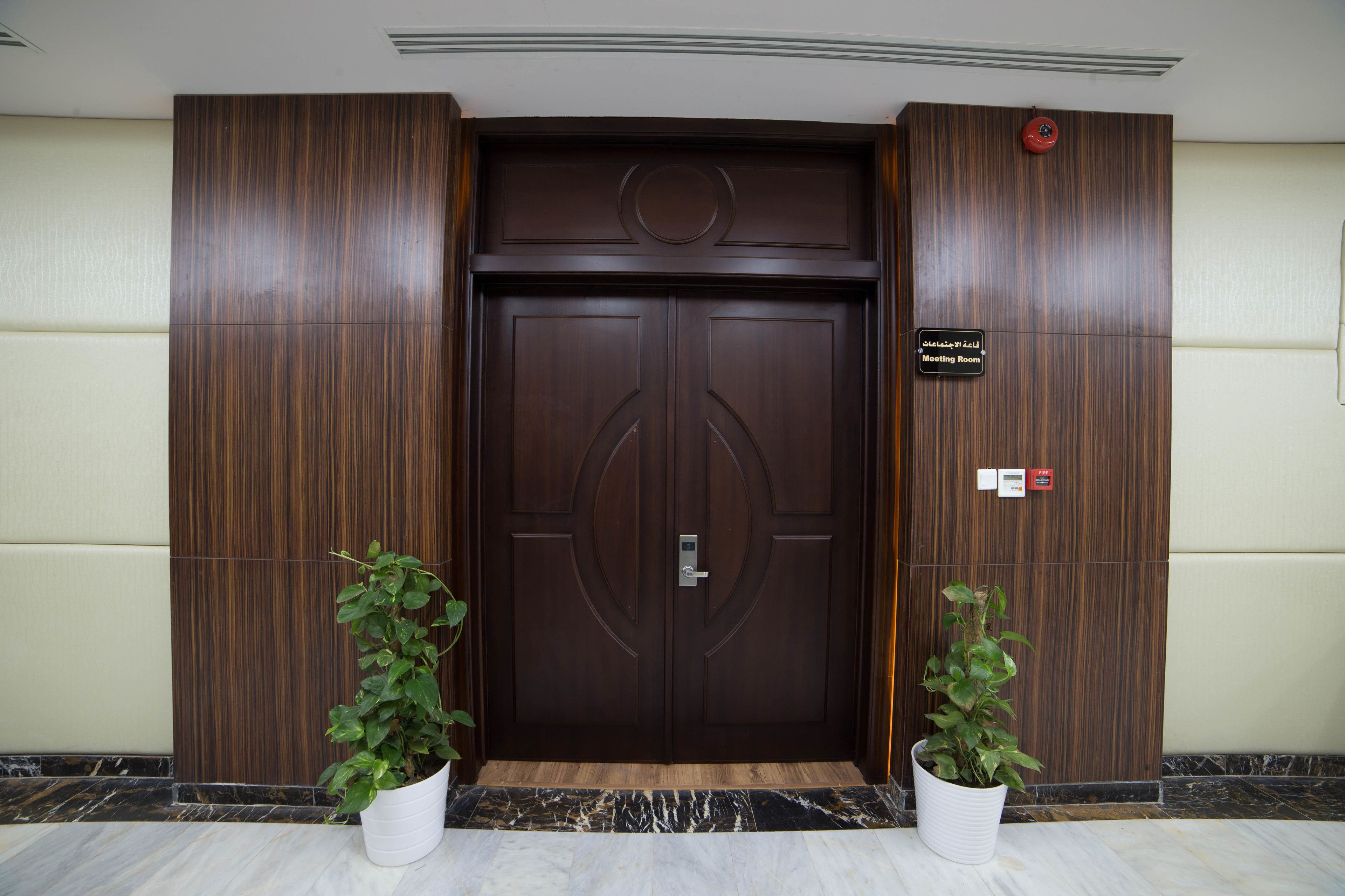 A double door with a sign indicating a "Meeting Room" and a "Conference Room."