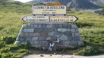 Un panel de señalización con indicaciones hacia varios destinos, incluyendo Cormet de Roselend, Les Chapieux, Bourg-St-Maurice, Beaufort y Albertville.