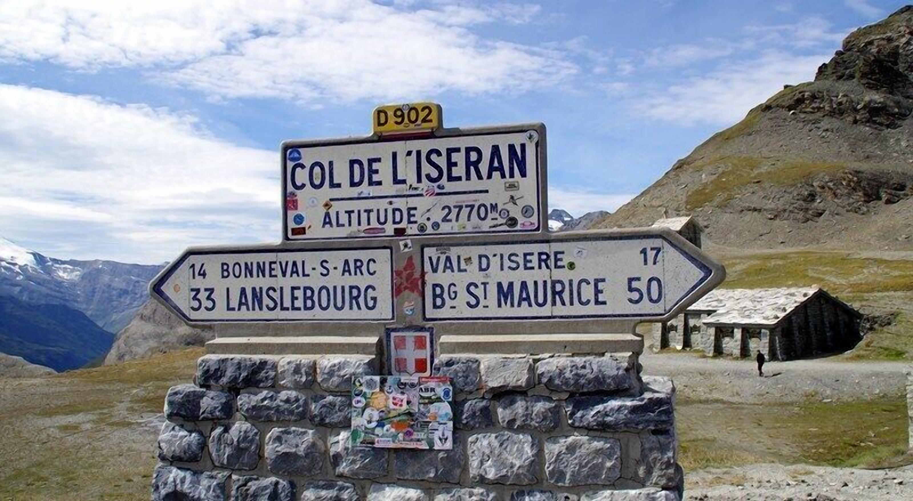 A directional signpost with multiple route indications, including distances to nearby locations.