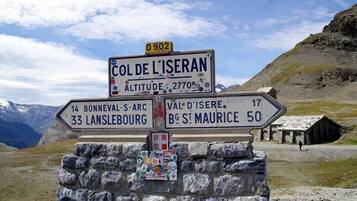 A directional signpost with multiple route indications, including distances to nearby locations.