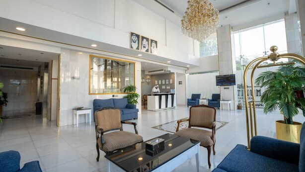 A spacious lobby with a reception desk, seating area, and large windows. - Platinum Alkhamseen Serviced Apartments (Taif)