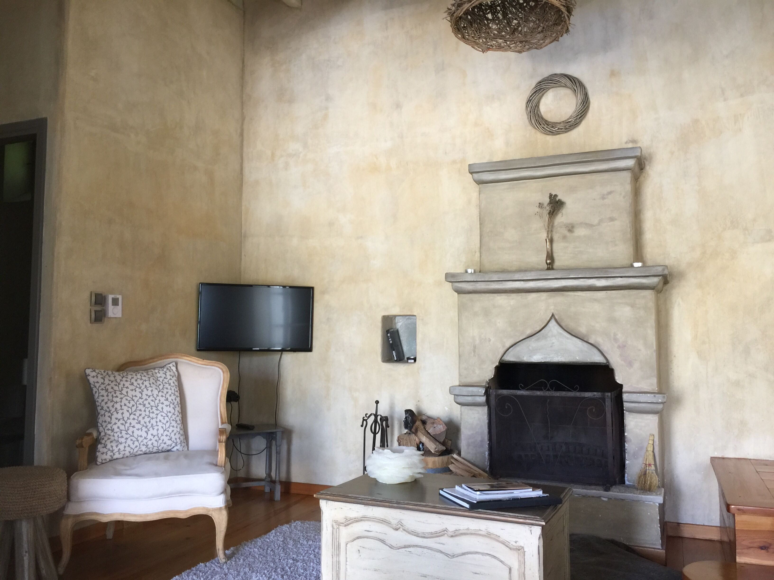 A living room with a fireplace, a television, a sofa, and a coffee table.