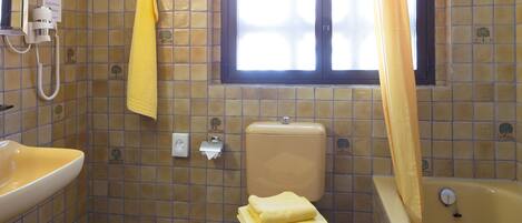 Un baño con inodoro, lavamanos y bañera.