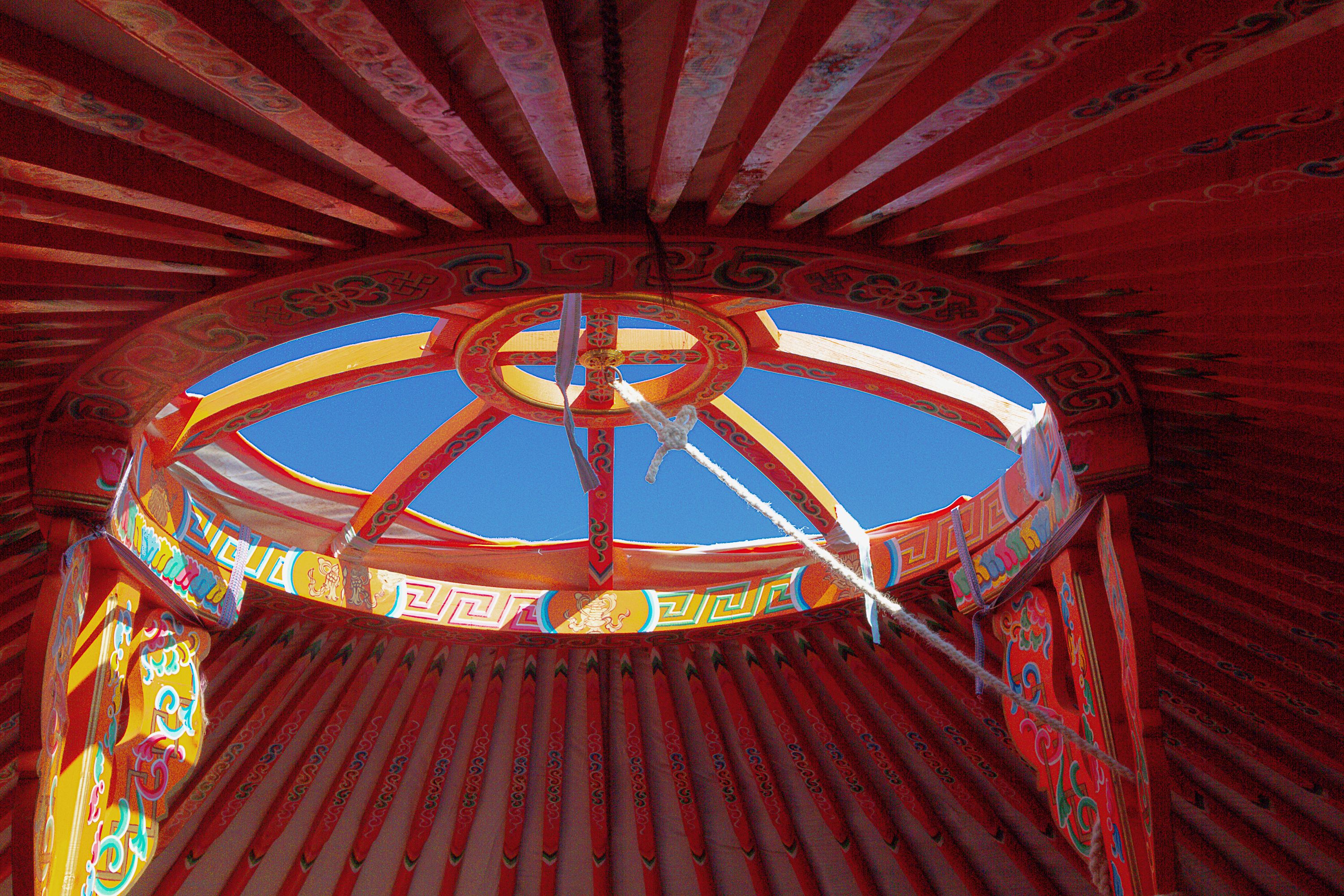 A traditional yurt with a circular roof and intricate patterns.