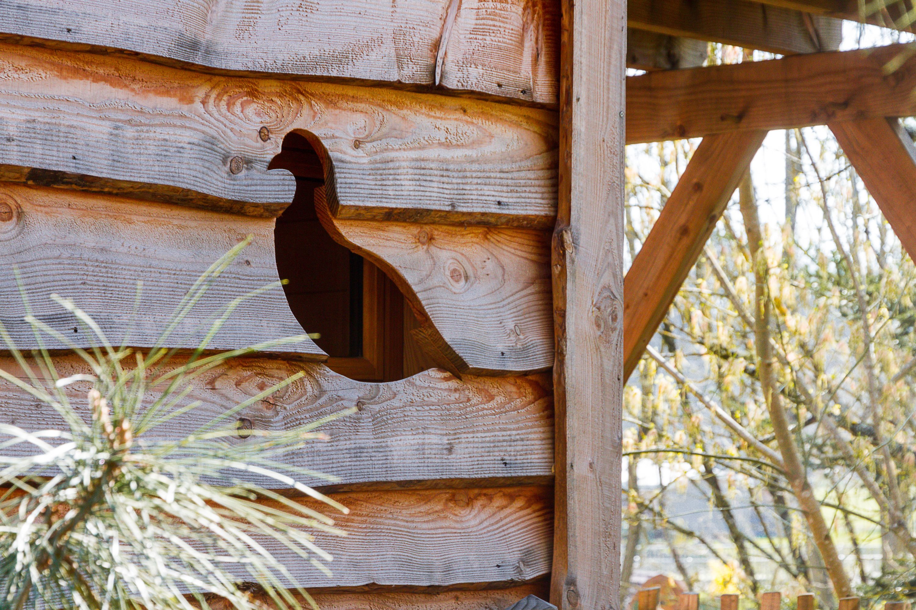Un muro di legno con un gallo intagliato.