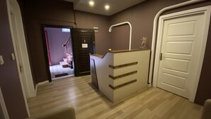 A hallway with a reception desk, a staircase, and a door. - Armoni City Hotel (Istanbul)