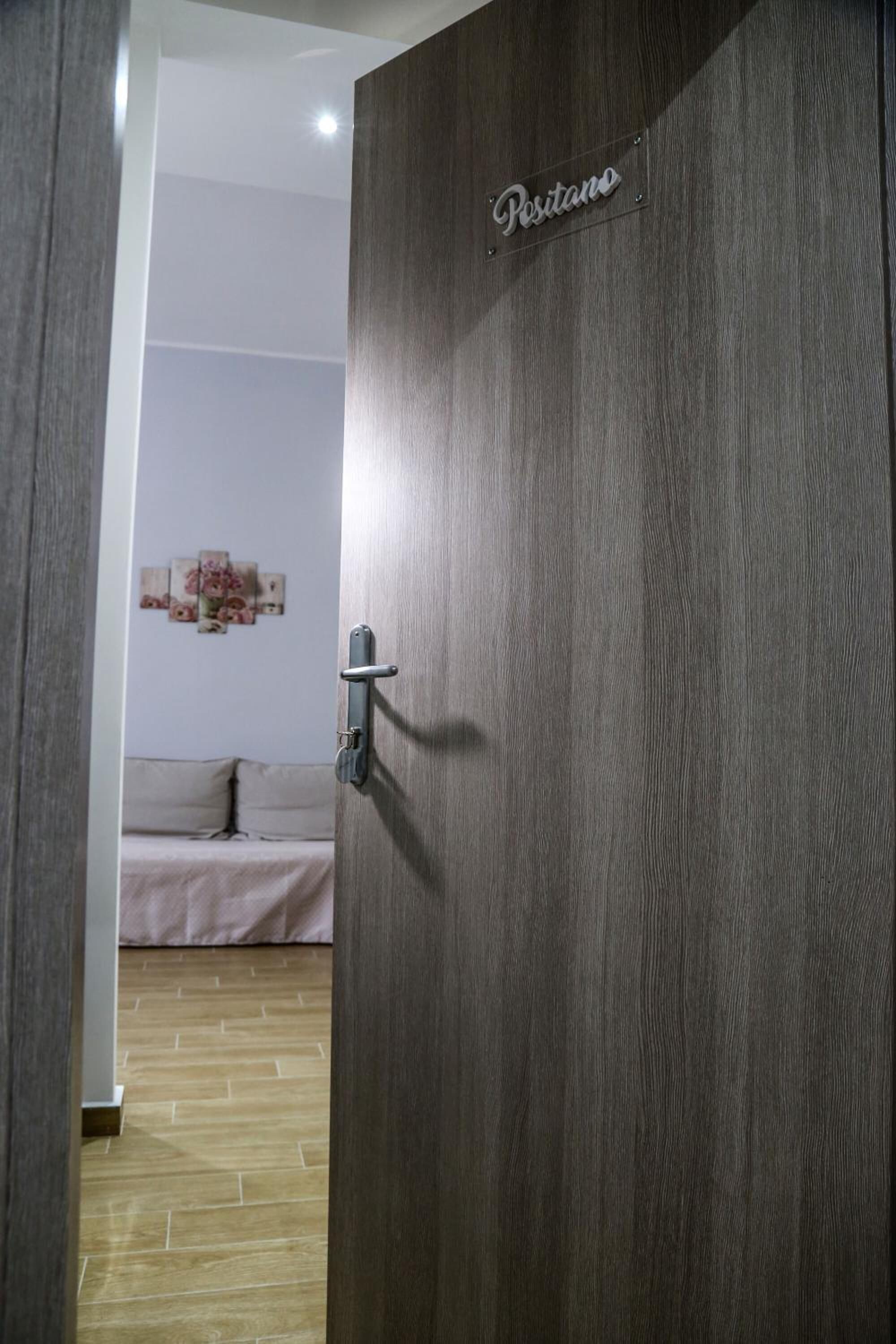 A wooden door with a sign that reads "Pestano".