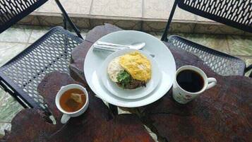Una mesa con un plato de comida, una taza de café y una taza de té.