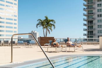 Outdoor pool, open 8:00 AM to 8:00 PM, pool umbrellas, sun loungers at Hyatt Centric Brickell Miami
