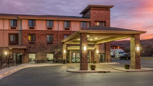 A hotel with a covered entrance, multiple windows, and a parking area. - Sleep Inn & Suites Moab near Arches National Park (Moab)