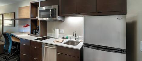 A modern kitchen with stainless steel appliances, a dishwasher, and a sink.