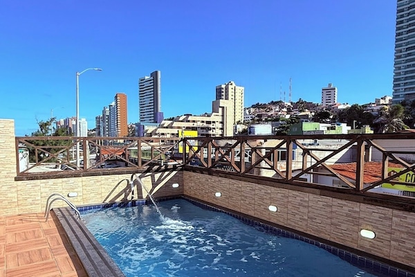 Una piscina al aire libre, sillones reclinables de piscina