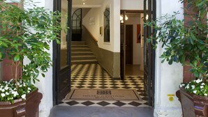 The entrance to Hotel Central with a checkered floor and a staircase leading inside. - Hotel Central Bastia (Bastia)
