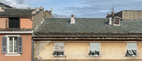 A row of buildings with multiple windows and a flat roof.