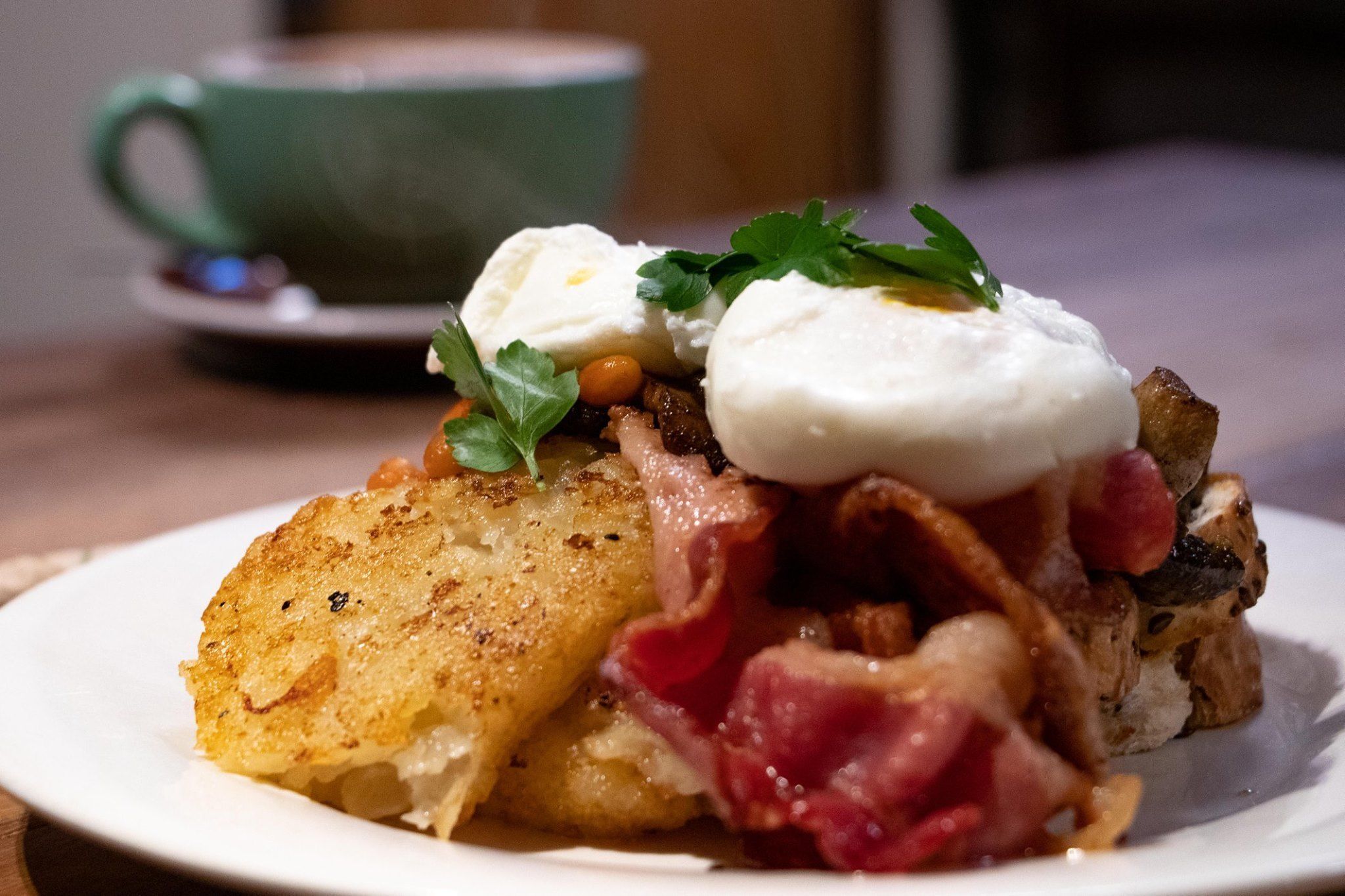 A plate of food with eggs, bacon, and potatoes.