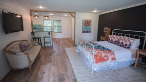 A bedroom with a bed, a desk, and a chair. - Detached Cottage In A Rural Woodsy Neighborhood. (Shreveport)