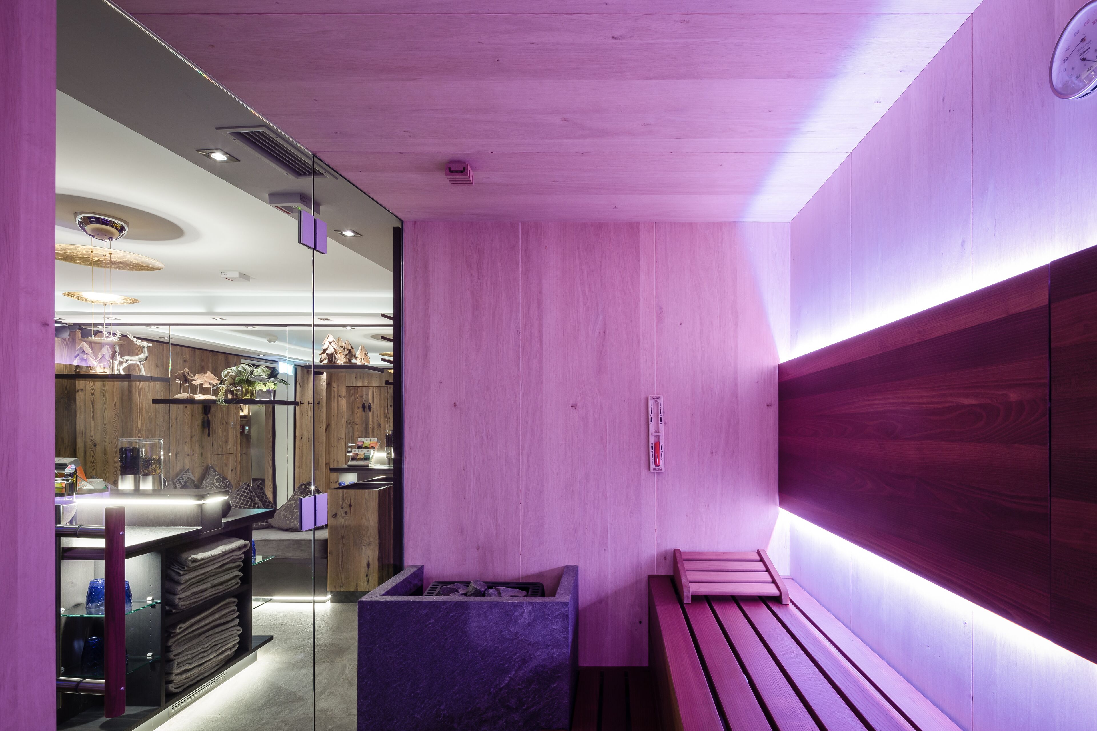 Un moderno spa con paredes de madera, un banco y una camilla de masaje.