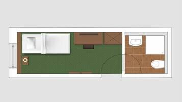 Ein Hotelzimmer mit Bett, kleinem Schreibtisch, Sofa und Badezimmer mit Toilette und Waschbecken.