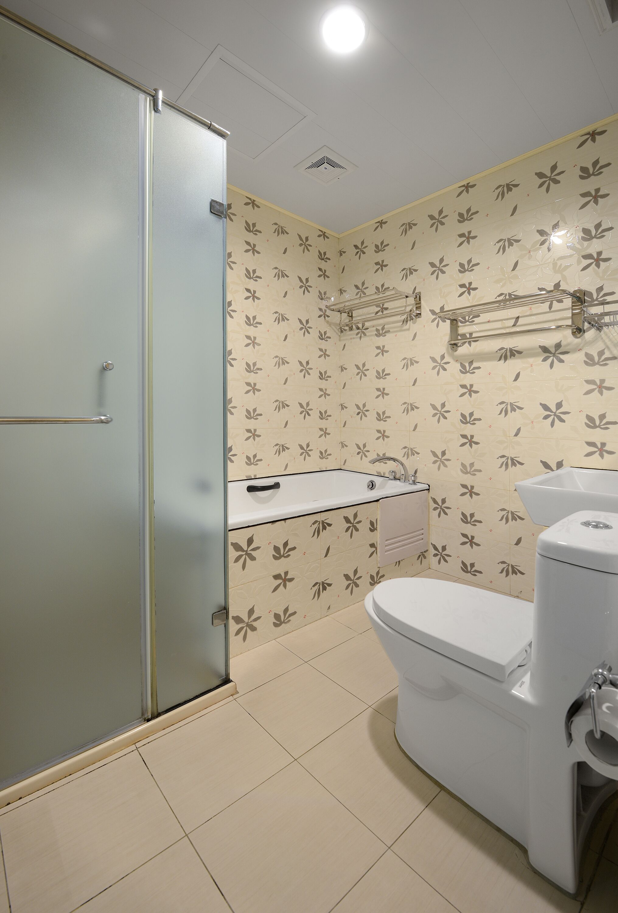 A bathroom with a toilet, sink, and shower.