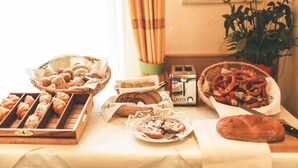 A table with various baked goods, including bread, pastries, and pretzels. - Lowen-seckenheim (Mannheim)