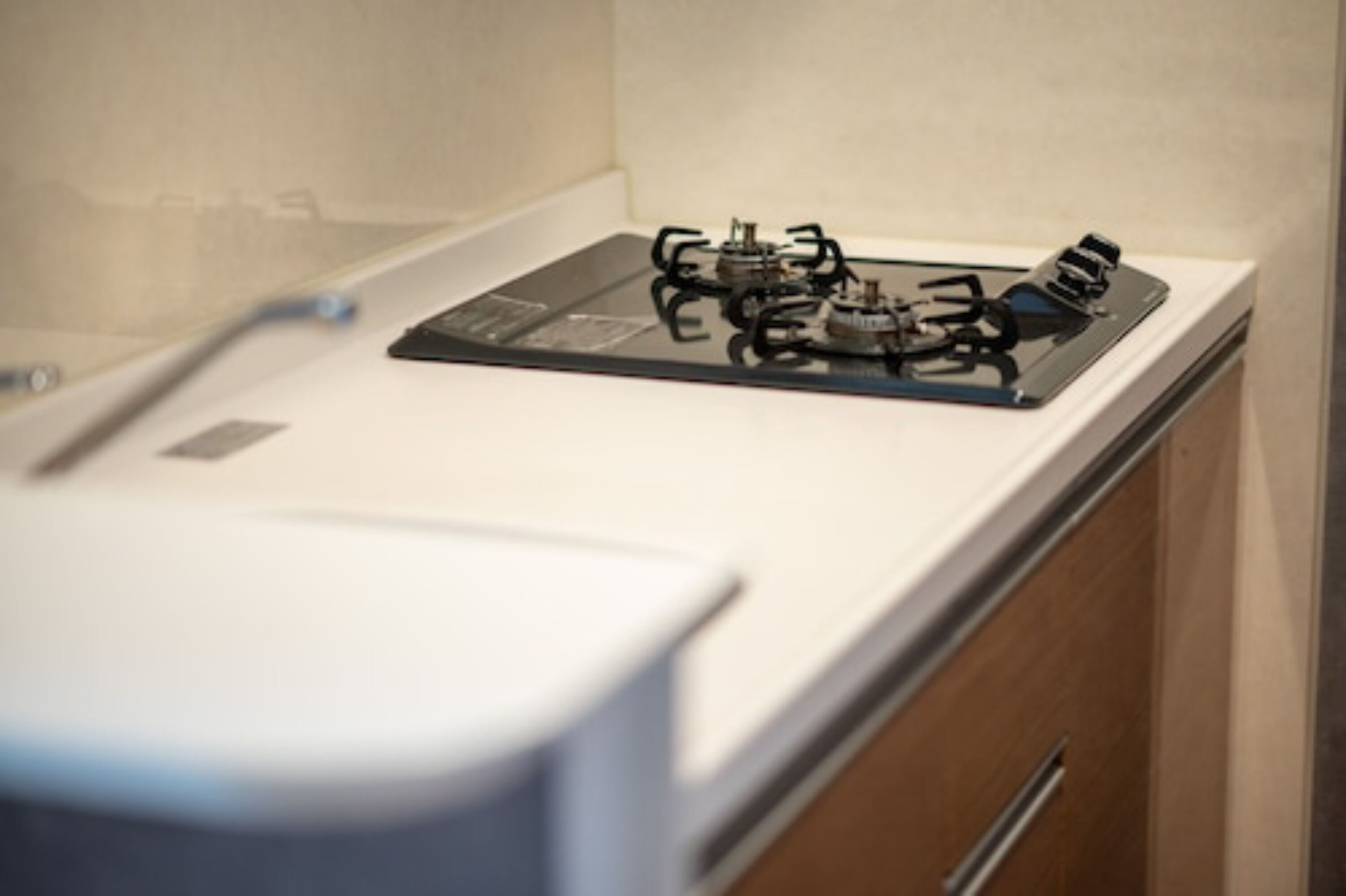 A kitchen with a gas stove and a white countertop.