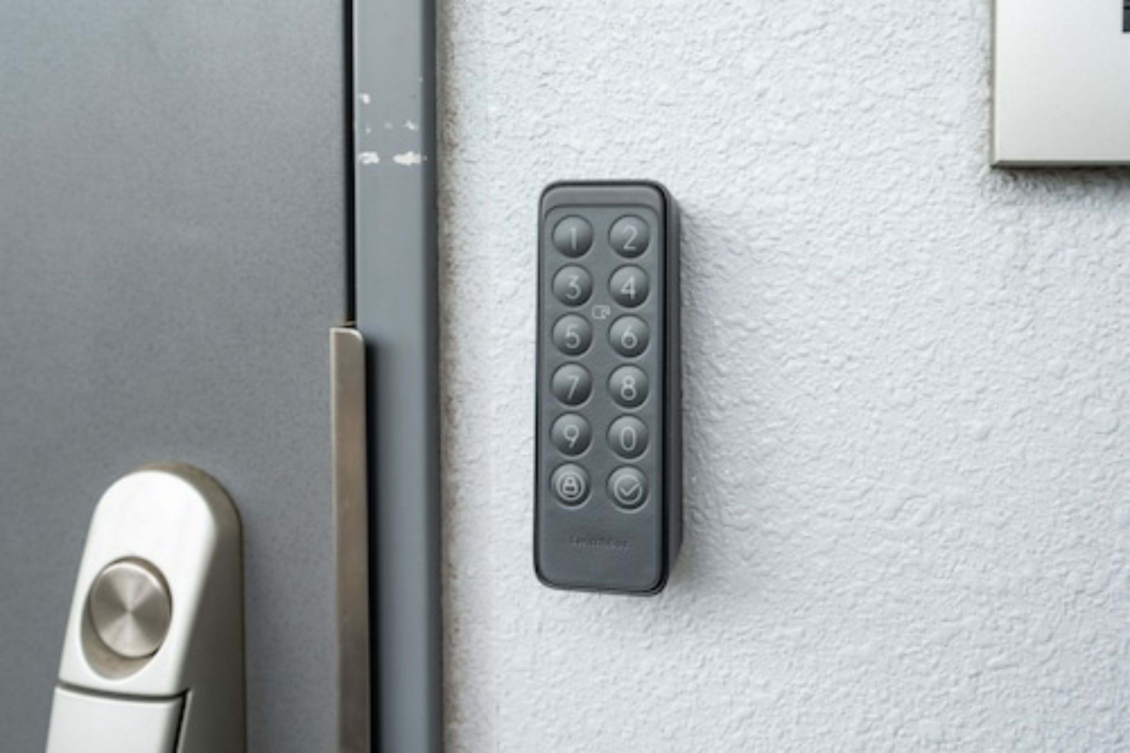 A door with a keyhole and a wall-mounted remote control.