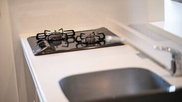 A kitchen with a gas stove and a sink.