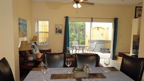 A dining area with a table set for four, chairs, and a ceiling fan. - Family friendly villa, gated community, spa, heated pool, close to theme parks. (Kissimmee)