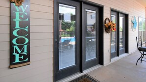 A building entrance with a 'WELCOME' sign, a 'No Smoking' sign, and a star decoration on the wall. - Luxury Living in a Country Setting and Minutes to Lubbock! (Wolfforth)