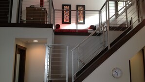 A staircase with metal railings, a clock on the wall, and artwork above. - GREAT Ski-in, Ski-out Condo at Snow Flower at Park City Mountain Resort ! (Park City)