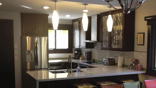 A modern kitchen with stainless steel appliances, a central island, pendant lighting, and a dining area with a patterned tablecloth. - GREAT Ski-in, Ski-out Condo at Snow Flower at Park City Mountain Resort ! (Park City)