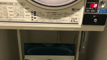 A front-loading Haier washing machine with a control panel and a digital display.