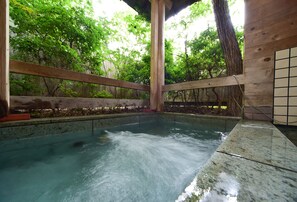 A wooden structure with a pool, surrounded by trees. - The Pageant (Nikko)