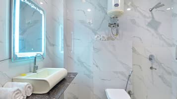 Shower, designer toiletries, towels, toilet paper