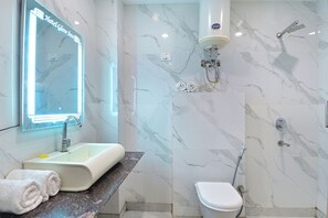 Shower, designer toiletries, towels, toilet paper