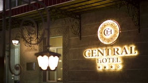 The exterior of the Central Hotel with a prominent illuminated sign and decorative ironwork.