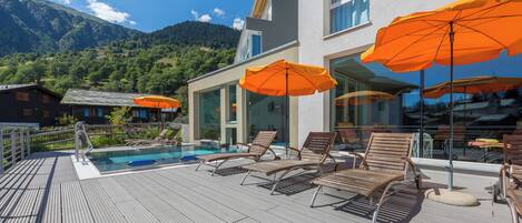 Indoor pool, outdoor pool, open 11 AM to 8 PM, pool umbrellas