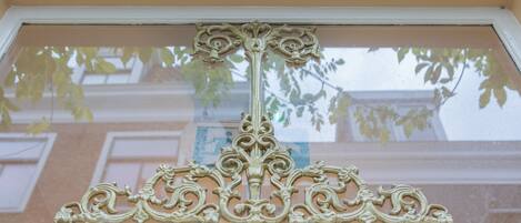 A window with ornate, symmetrical metalwork.