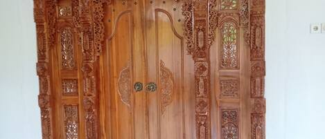 A large wooden cabinet with intricate carvings and a central door.