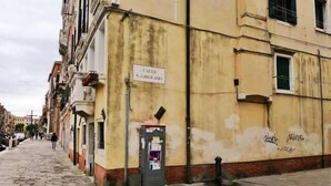 A narrow cobblestone street with buildings on either side. A sign on one building reads "Calle N. Ciroloamo." - Mario Apartment 3028 F (Venice)